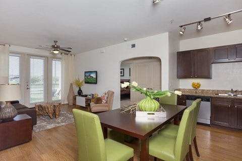 a dining room and living room with a table and chairs